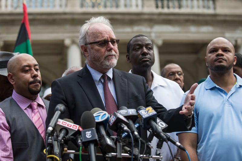 Three members of the Central Park Five stand behind their lawyer after winning a $41 million settlement from New York City in 2014.