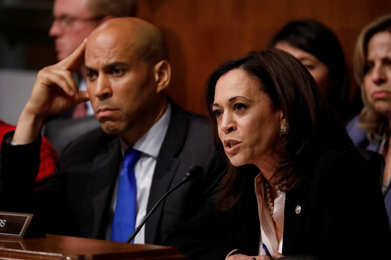 Kamala Harris asks a question at a Senate Committee as Corey Booker sits to her right