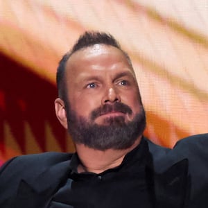 Garth Brooks on stage with his arms spread to his side.