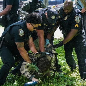 Police officers arrest a demonstrator during a pro-Palestinian protest against the war in Gaza at Emory University on April 25, 2024, in Atlanta, Georgia.