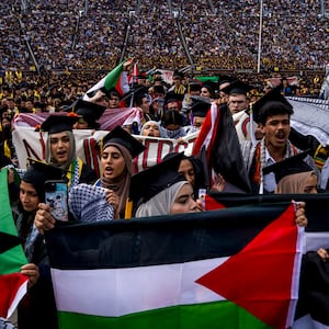 Students demonstrate during a Pro-Palestinian protest during the University of Michigan's spring commencement ceremony on May 4, 2024 at Michigan Stadium in Ann Arbor, Michigan.