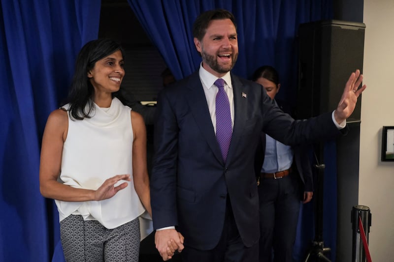 JD and Usha Vance hold hands at an event.