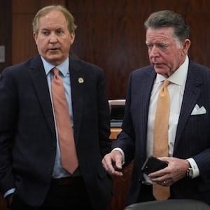 Texas Attorney General Ken Paxton, left, appears in the 185th District Court with Dan Cogdell, one of his defense attorneys, for a hearing in his securities fraud case Friday, Feb. 16, 2024, at the Harris County criminal courthouse in Houston.