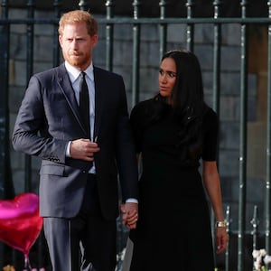 Prince Harry and Meghan Markle walk outside Windsor Castle.