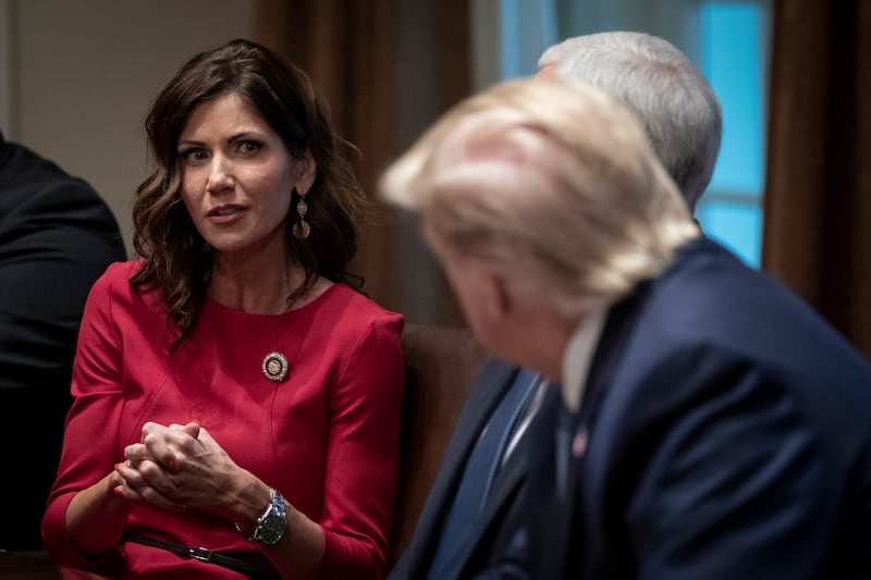 Governor of South Dakota Kristi Noem speaks to Donald Trump