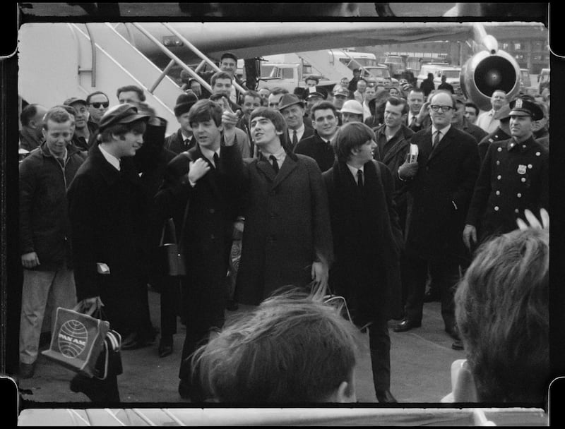 The Beatles departing from their plane.