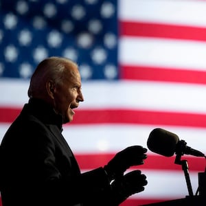 Image of Joe Biden speaking, with American flag in the background.