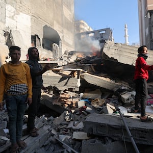 Palestinians inspect a house destroyed in an Israeli strike, amid the ongoing conflict between Israel and the Palestinian Islamist group Hamas, in Khan Younis, in the southern Gaza Strip, December 4, 2023. 