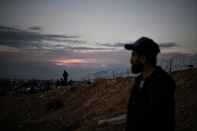 A photo of Palestinian refugees standing near the Egyptian border