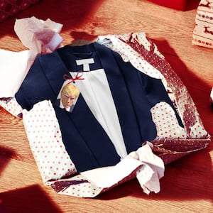 A photo illustration showing an unwrapped gift of Donald Trump’s suit from his Georgia mugshot.