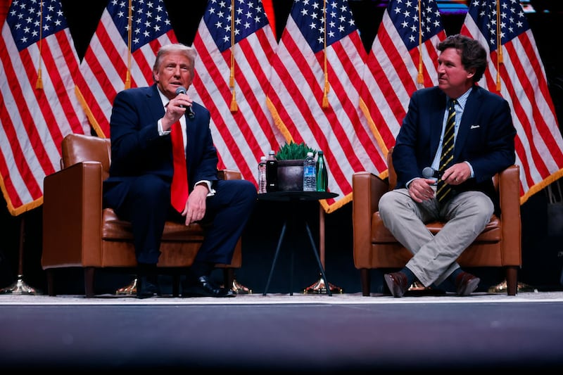 Republican presidential nominee, former President Donald Trump sits down for a conversation with Tucker Carlson during his Live Tour at the Desert Diamond Arena on October 31, 2024 in Phoenix, Arizona. With less than a week until Election Day, Trump is campaigning for re-election in New Mexico and the battleground states of Nevada and Arizona on Thursday.