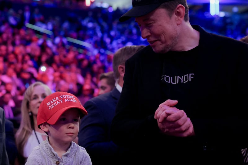 Tesla CEO and X owner Elon Musk stands next to his son during a rally for Republican presidential nominee and former U.S. President Donald Trump at Madison Square Garden, in New York, U.S., October 27, 2024. REUTERS/Carlos Barria