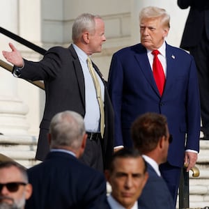 Former U.S. President Donald Trump (R) observes a changing of the guard at the Tomb of the Unknown Soldier at Arlington National Cemetery.