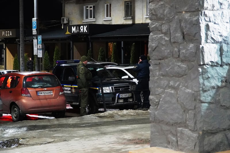 A Ukrainian military member and a police officer looking for men to check in western Ukraine.