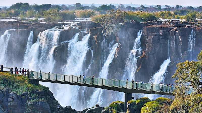 Tourists cross the Knife Edge bridge at Victoria Falls