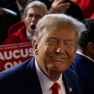 Former President Donald Trump rallies with supporters at a "commit to caucus" event in Ankeny, Iowa.