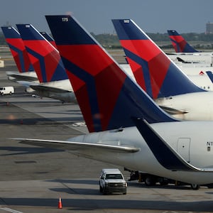 Six Delta Air Lines planes sit at their gates at an airport in New York City.