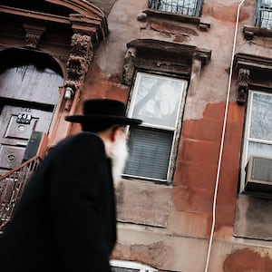 hasidic men walking through a jewish orthodox neighborhood in williamsburg brooklyn measles mmr vaccine anti vaxxer vaccination