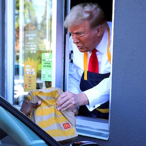 Republican presidential nominee and former President Donald Trump serves food at a McDonalds restaurant in Feasterville-Trevose, Pennsylvania on Oct. 20, 2024.