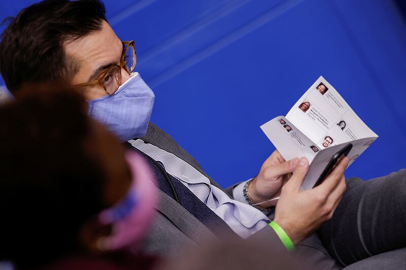 White House Deputy Press Secretary TJ Ducklo holds a paper sheet with names and headshots of reporters during a press briefing at the White House.