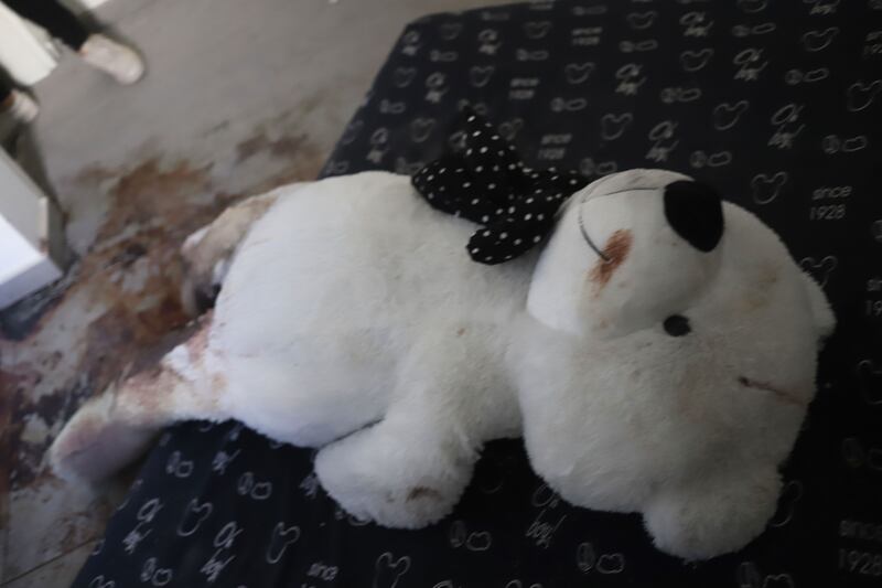 A photograph of a toy bear in a damaged building in Kibbutz Be’eri and Kibbutz Kfa