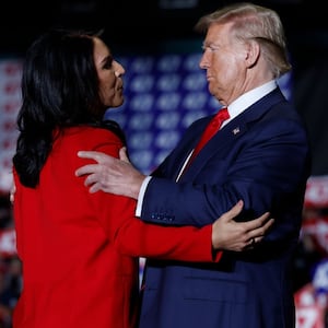 Tulsi Gabbard and Donald Trump embrace during a campaign rally at the Greensboro Coliseum on Oct. 22, 2024, in Greensboro, North Carolina.