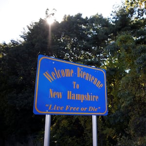 A welcome sign at the New Hampshire border that says “Live Free or Die.”