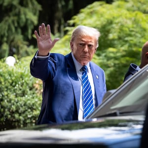 Ex-President and convicted felon Donald Trump waves to supporters