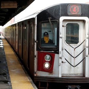 An underground subway stops at a station in the Bronx.