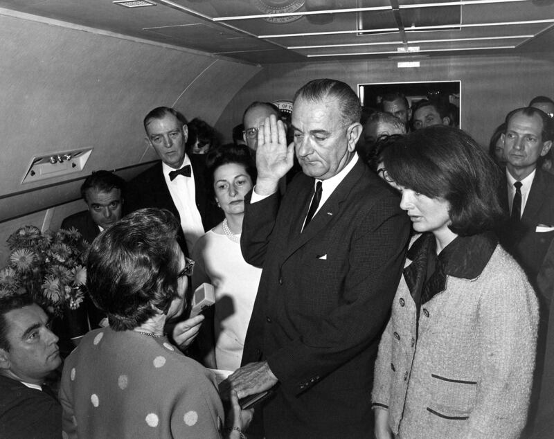 Judge Sarah T. Hughes (L) administers the Presidential Oath of Office to then acting U.S. President Lyndon Baines Johnson