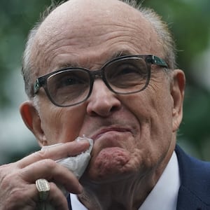 A photo of Rudy Giuliani wiping his mouth.