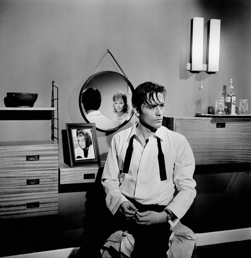 Alain Delon with his bowtie undone on the set of "Mélodie En Sous-Sol" in 1962