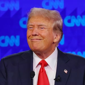 Donald Trump smirks on stage during a debate against Joe Biden.