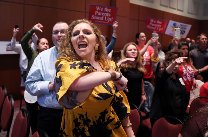 Angry parents and community members protest after a Loudoun County School Board meeting was halted by the school board because the crowd refused to quiet down.