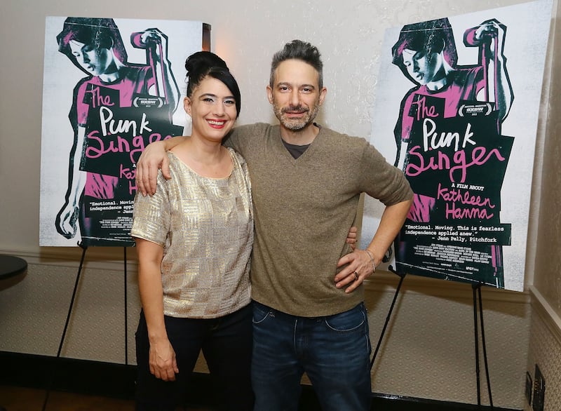 Kathleen Hanna and Adam Horovitz hug and pose for a photo.