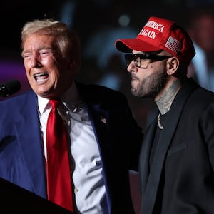 Republican presidential nominee, former U.S. President Donald Trump, (L) appears on stage with recording artist Nicky Jam during a campaign rally at The Expo at World Market Center Las Vegas on September 13, 2024 in Las Vegas, Nevada