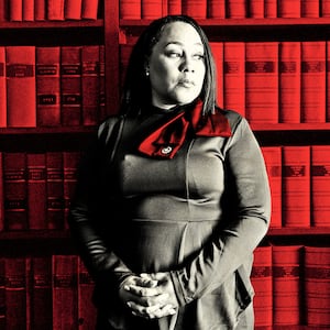 A photo illustration of Fani Willis where she is standing in front of a book case