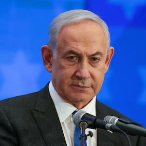 Israeli Prime Minister Benjamin Netanyahu before a blue background.