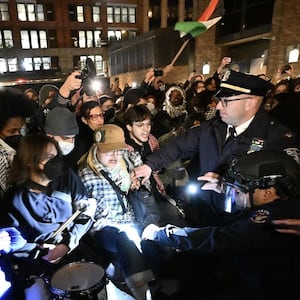 Protesters clash with a NYPD officer on the campus of NYU.