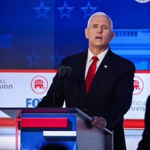 Former U.S. Vice President Mike Pence looks past former biotech executive and fellow Republican presidential candidate Vivek Ramaswamy during a break