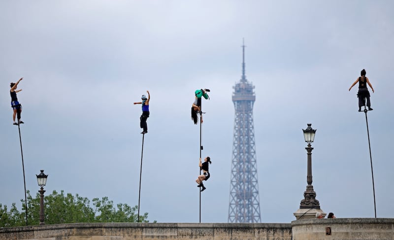 Performers practice nearby the river Seine with the Eiffel Tower in the background ahead of the opening ceremony of the Paris 2024 Olympics