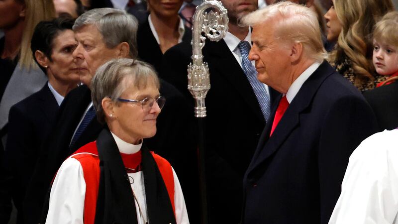 Bishop Mariann Edgar Budde (L) arrives as U.S. President Donald Trump looks on during the National Prayer Service at Washington National Cathedral on January 21, 2025 in Washington, DC.