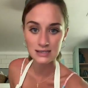 Lilly Gaddis speaks while wearing an apron in a TikTok video.