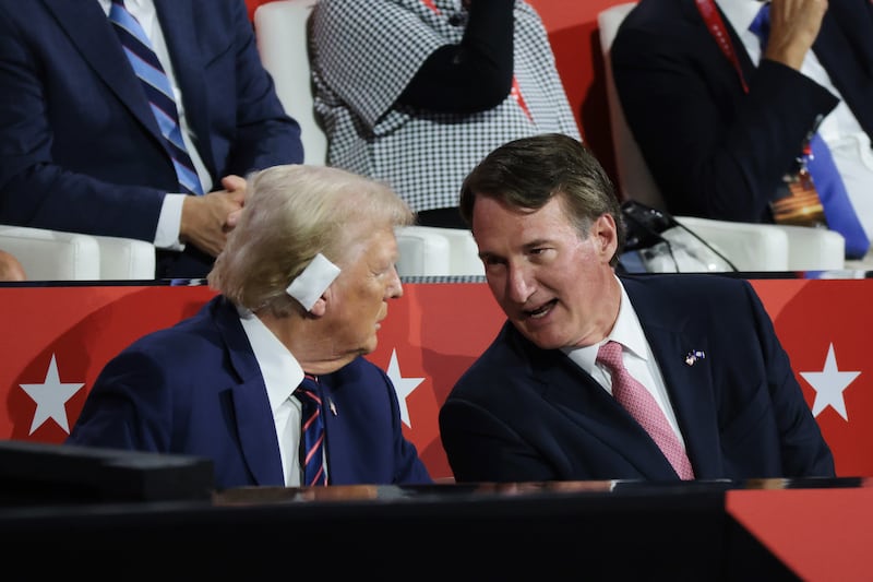 Republican presidential candidate, former U.S. President Donald Trump talks to Virginia Gov. Glenn Youngkin on the third day of the Republican National Convention