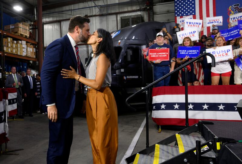 Republican vice presidential nominee J.D. Vance walks on stage with his wife, Usha, before speaking at a rally at trucking company in Erie, Pennsylvania.