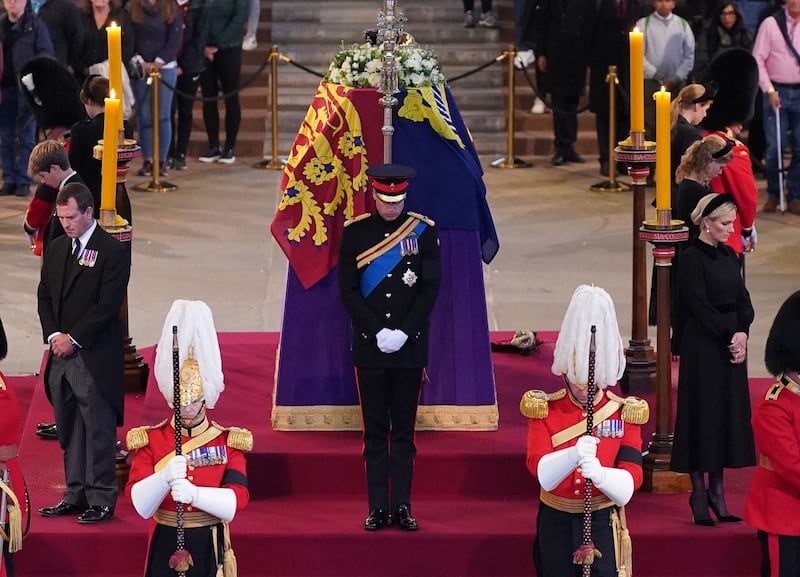 Prince William, Prince of Wales, Prince Harry, Duke of Sussex (obscured), Princess Eugenie of York, Princess Beatrice of York, Peter Phillips, Zara Tindall, Lady Louise Windsor, James, Viscount Severn arrive to hold a vigil to honor Queen Elizabeth II.