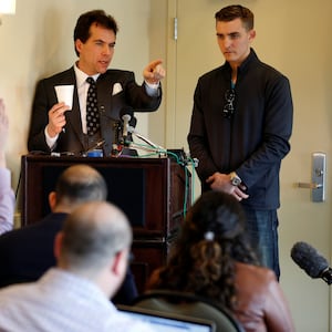 Jack Burkman, a lawyer and Republican operative, and Jacob Wohl (R), an internet activist and supporter of U.S. President Donald Trump, speak during a news conference on November 1, 2018.