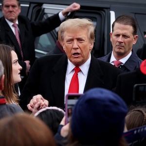 Former President Donald Trump greets supporters as makes a visit to a polling station on election day in the New Hampshire presidential primar