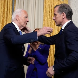 US President Joe Biden hugs his son Hunter Biden (R) after addressing the nation about his decision to not seek reelection, in the Oval Office at the White House in Washington, DC, on July 24, 2024. 