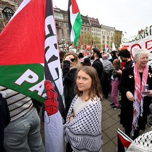 Climate activist Greta Thunberg stands in a crowd at the protest